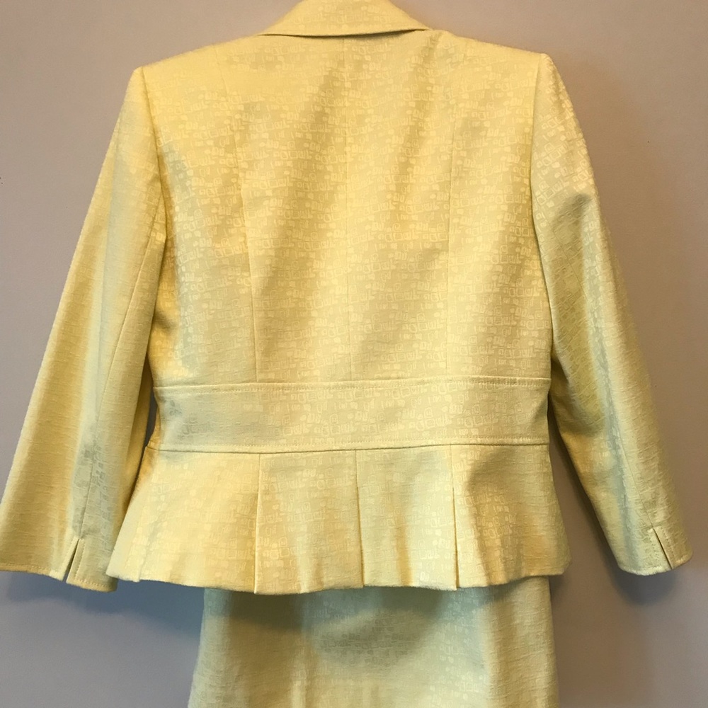 Below the knee pencil skirt and blazer with yellow stone buttons